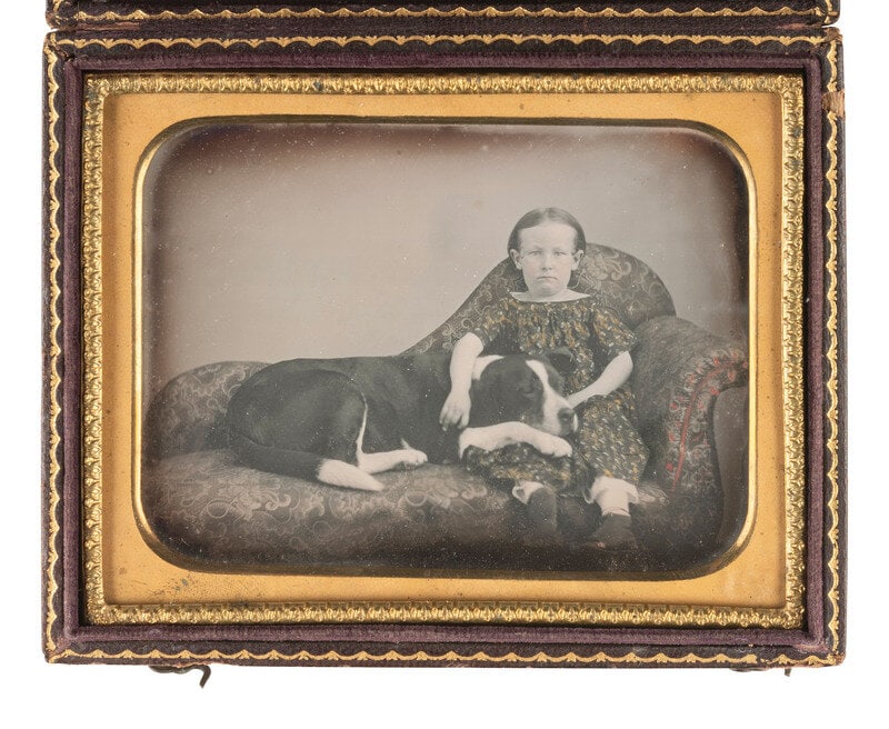 [EARLY PHOTOGRAPHY]. Quarter plate daguerreotype of a young girl posed with her dog. : [EARLY PHOTOGRAPHY]. Quarter plate daguerreotype of a young girl posed with her dog. Landscape-oriented portrait of a young girl seated on an upholstered chaise with her arm around her adorable furry