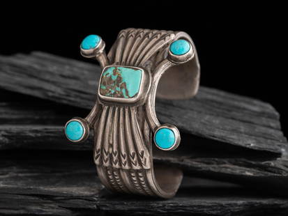 Navajo Ingot and Turquoise Cuff Bracelet: Navajo Ingot and Turquoise Cuff Bracelet set with five stones on the central design and one stone on each terminal; not marked cuff width 1-7/8 inches, interior circumference 6 inches + gap length 1-1