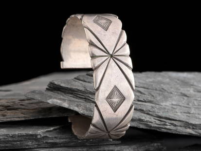 Navajo Arts and Crafts Guild (Institution, formed 1941) Navajo Chiseled and Stamped Silver Cuff: Navajo Arts and Crafts Guild (Institution, formed 1941) Navajo Chiseled and Stamped Silver Cuff Bracelet marked with the horned moon hallmark and NAVAJO cuff width 7/8 inch, interior circumference 6 i