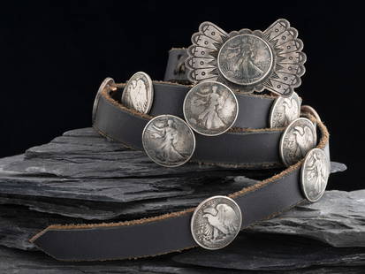 Navajo Silver Concha Belt: Navajo Silver Concha Belt third quarter 20th century fifteen Liberty Silver Dollar Conchas and winged buckle; marked STERLING buckle height 2 inches x length 2-1/2 inches, belt length 44 inches, total