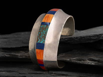Duane Maktima (Laguna-Hopi, b. 1954) Sterling Silver and Inlay Cuff Bracelet: Duane Maktima (Laguna-Hopi, b. 1954) Sterling Silver and Inlay Cuff Bracelet set with turquoise, spiny oyster, coral, and lapis; marked with artist's DM and bird hallmark and Sterling cuff width 1-3/8