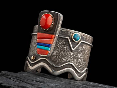 Edison Cumimngs (Diné, b. 1962) Sterling Silver Tufa Cast Cuff Bracelet, with 14K Gold Accents: Edison Cumimngs (Diné, b. 1962) Sterling Silver Tufa Cast Cuff Bracelet, with 14K Gold Accents and Inlay set with iron wood, coral, turquoise, and lapis; signed E. CUMMINGS and marked 14K? cuff w