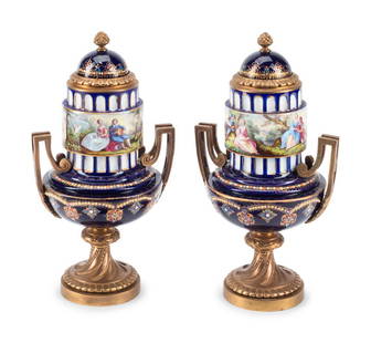 A Pair of Gilt Bronze Mounted Sèvres Style Porcelain Urns: A Pair of Gilt Bronze Mounted S&#232;vres Style Porcelain Urns Late 19th Century Height 11 x width 6 x depth 4 1/2 inches. This lot is located in Cincinnati.