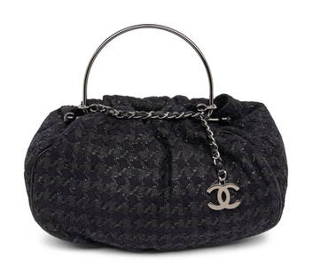 CHANEL, BLACK TWEED BAG: CHANEL, BLACK TWEED BAG Tote bag in black wool tweed with black leather piping and silver-tone hardware. Interlocking metal loop closures and metal loop handle/ interwoven leather-metal chain handle w