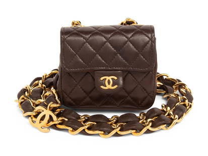 CHANEL, MINI CLASSIC FLAP ON CHAIN BELT: CHANEL, MINI CLASSIC FLAP ON CHAIN BELT Mini classic flap bag in quilted chocolate brown lambskin leather with gold-tone hardware; bag is removable from belt & hung on a strap with a lobster clasp