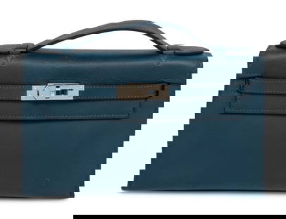 HERMÈS, DEEP BLEU KELLY POCHETTE: HERMÈS, DEEP BLEU KELLY POCHETTE Hermès Kelly Pochette bag in Deep Bleu Swift leather with palladium hardware. Label: Hermès Code: M in Square Date: 2009 Country of Origin: France Appro