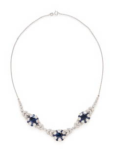 SAPPHIRE AND DIAMOND NECKLACE: SAPPHIRE AND DIAMOND NECKLACE Three oval sapphires measuring approximately 9.00 x 6.30 mm, calibré cut sapphires, and round diamonds weighing approximately 3.90 carats total. 18 karat white