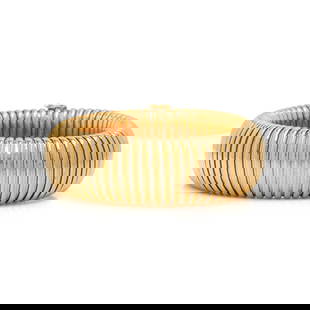 CARTIER, YELLOW GOLD AND STEEL TUBOGAS BRACELET: CARTIER, YELLOW GOLD AND STEEL TUBOGAS BRACELET Designed as an 18 karat yellow link and steel tubogas band. 8 inches long, 7/8 inch wide. Stamp: Cartier X 1109 750 (maker's mark). Gross weight: 71.15
