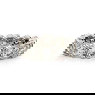 PLATINUM AND DIAMOND ETERNITY RING: PLATINUM AND DIAMOND ETERNITY RING Round and modified princess cut diamonds weighing approximately 4.50 carats total. Platinum. Ring size 6. Gross weight: 5.45 dwt. This lot is located in Chicago.
