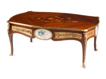 A Louis XV Style Gilt Bronze and Porcelain Mounted Low Table: A Louis XV Style Gilt Bronze and Porcelain Mounted Low Table 20th Century Height 18 1/2 x width 47 x depth 28 1/2 inches. This lot is located in Cincinnati.