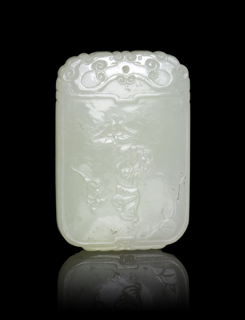 A Carved Jade Plaque, Height 1 3/4 inches.: A Carved Jade Plaque, of a pale celadon stone and of cartouche form, having a figure and bats in relief. Height 1 3/4 inches.