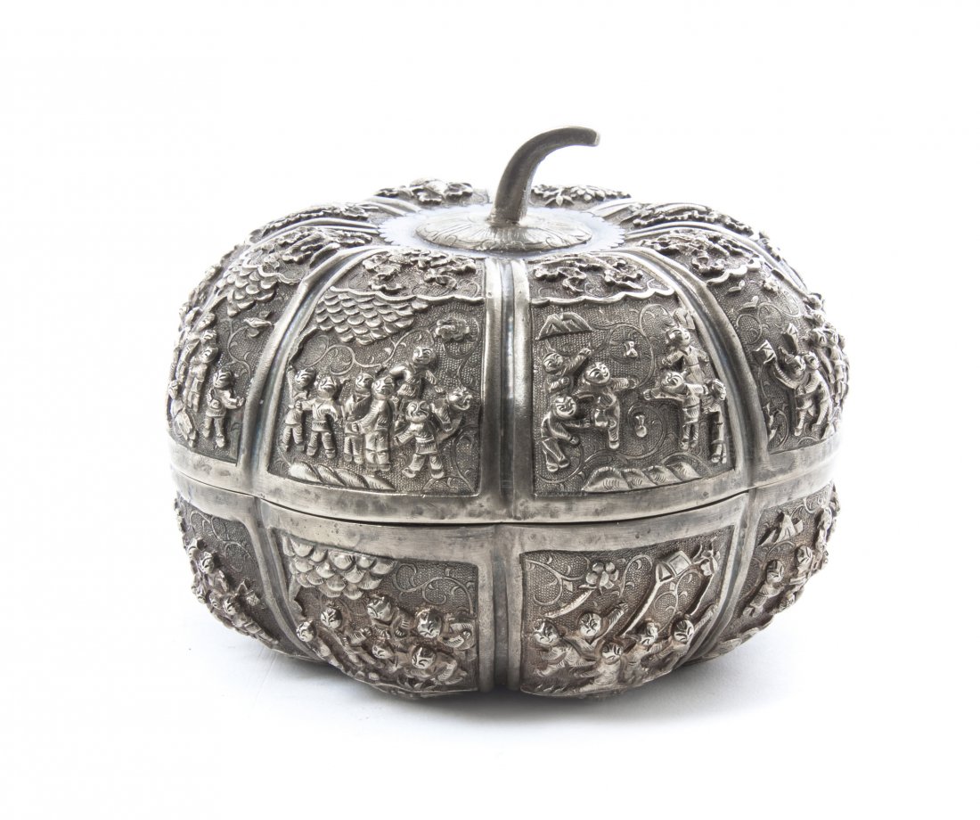 A Chinese Gilt Silver Lobed Covered Box, Diameter 4 5/8: A Chinese Gilt Silver Lobed Covered Box, Qing Dynasty, modeled as a pumpkin with squared reserves cast in deep relief depicting boys at play, with bajixiang auspicious emblems on the cover and bats ca