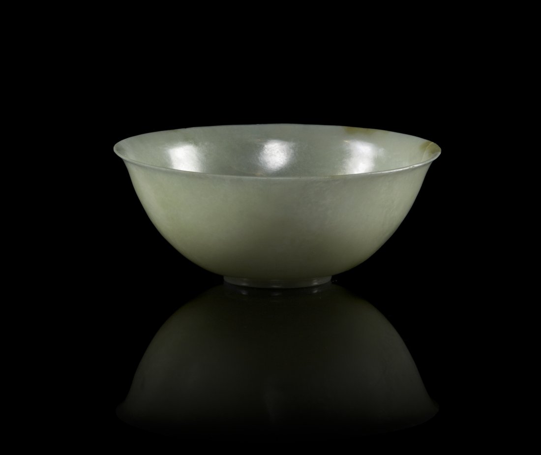 A Chinese Carved Jade Bowl, Diameter 4 inches.: A Chinese Carved Jade Bowl, of a pale celadon colored stone with fleck inclusions and veining, of circular form and raised on a circular foot ring. Diameter 4 inches.