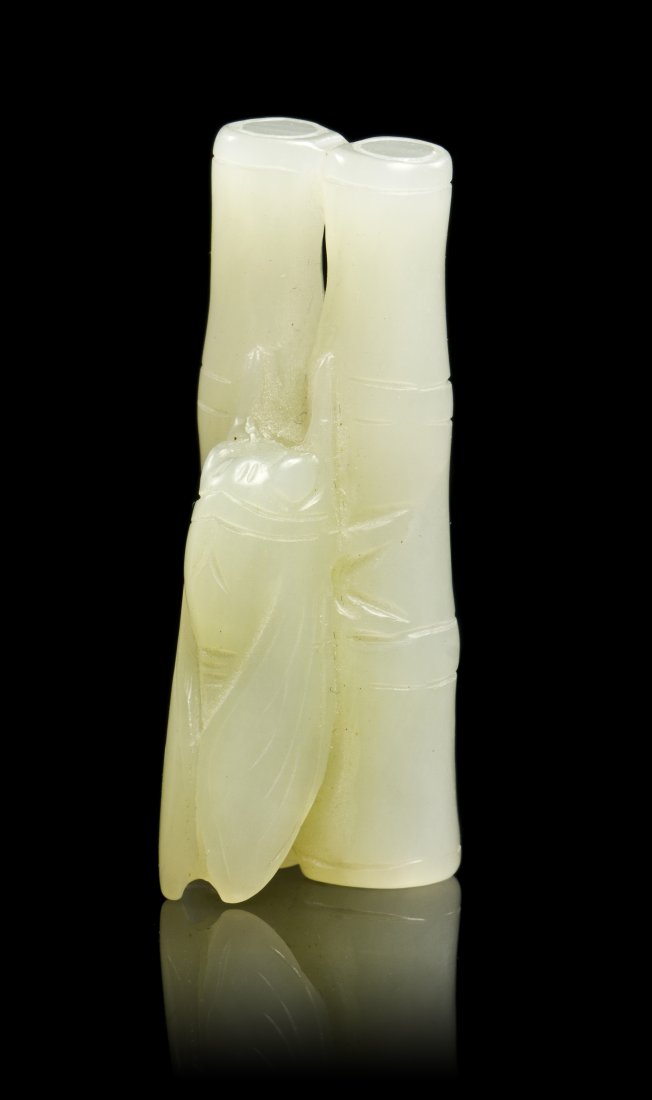 A Chinese Carved White Nephrite Jade Toggle, Length 1 3: A Chinese Carved White Nephrite Jade Toggle, depicting a cicada on a bundle of two bamboo segments. Length 1 3/4 inches. Property from the Collection of Stephen Payne, West Palm Beach, Florida Notes: 