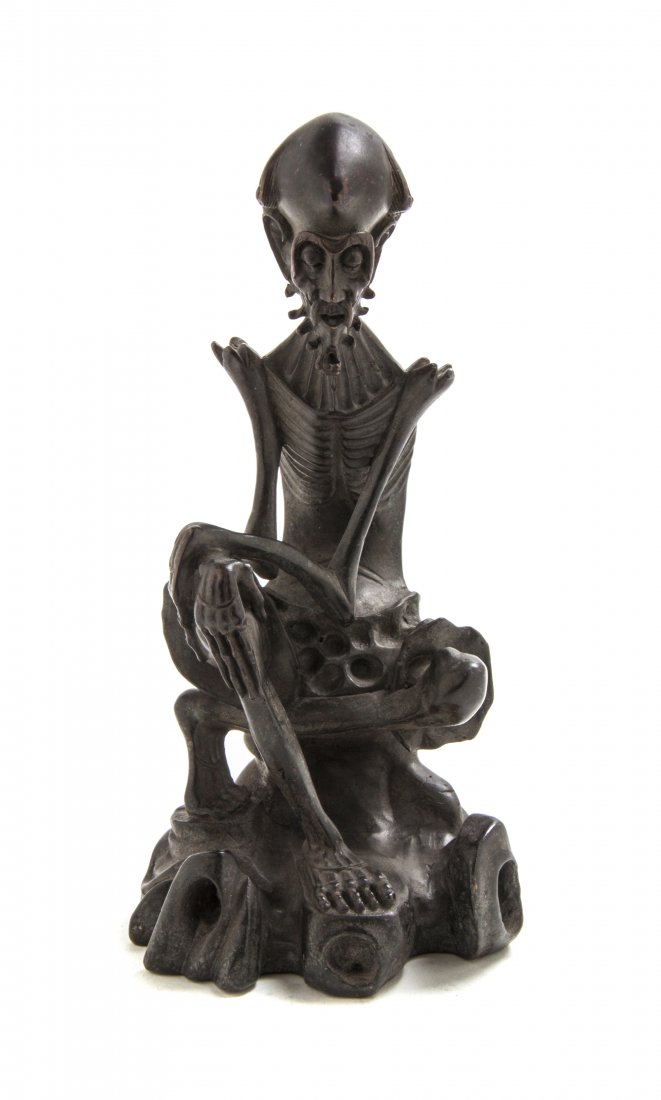 A Chinese Bronze Figure of an Ascetic Luohan, Height 9 : A Chinese Bronze Figure of an Ascetic Luohan, the emaciated figure depicted with exaggerated cranium and barbed beard, seated with his limbs crossed on a rockwork seat. Height 9 inches. Property from 
