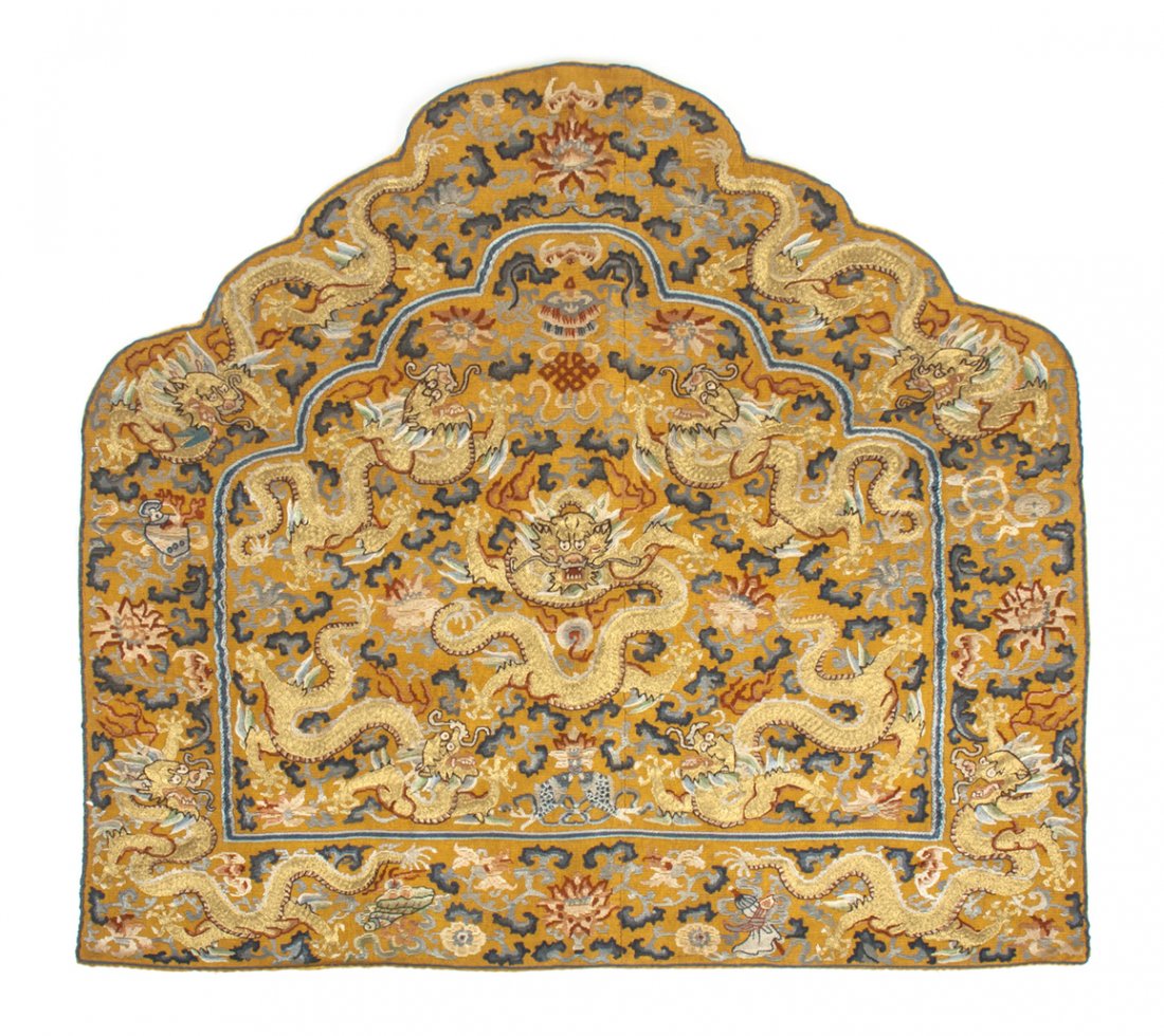 A Chinese Embroidered Silk Chair Back Panel, Height 25 : A Chinese Embroidered Silk Chair Back Panel, having a shaped top border, decorated with nine five-claw dragons and centered with a flaming pearl, with auspicious emblems throughout including the doubl