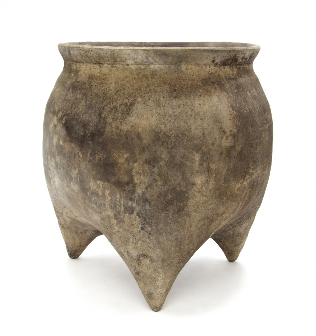 A Chinese Pottery Tripod Vessel, Height 11 1/2 inches.: A Chinese Pottery Tripod Vessel, Han Dynasty, having an everted mouth rim above the bulbous body, terminating in pointed feet. Height 11 1/2 inches. Property from the Collection of Mr. Larry Belger, K
