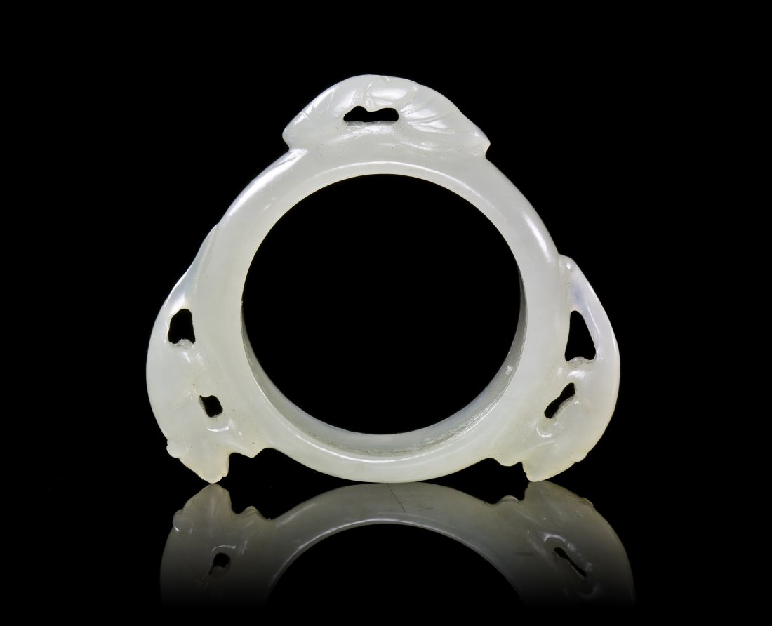 A Carved Jade Ring with Mice, Width 1 5/8 inches.: A Carved Jade Ring with Mice, of a near-white stone, the circular ring surrounded by mice. Width 1 5/8 inches.
