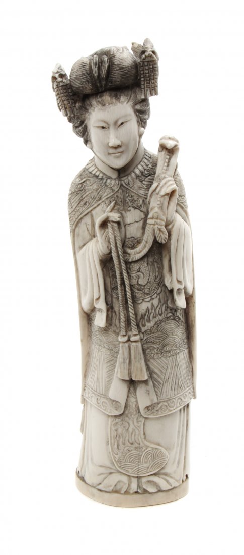 A Chinese Carved Ivory Figure of an Empress, Height 10 : A Chinese Carved Ivory Figure of an Empress, the figure depicted holding a tasseled ruyi scepter. Height 10 5/8 inches.