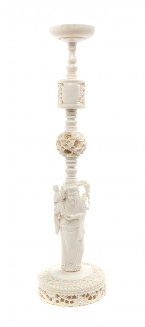 A Chinese Carved Ivory Puzzle Ball Stand, Height 14 inc: A Chinese Carved Ivory Puzzle Ball Stand, having a figural support and pierced elements. Height 14 inches. Property from the Dr. Myrna Salud Living Trust, Marion, Indiana