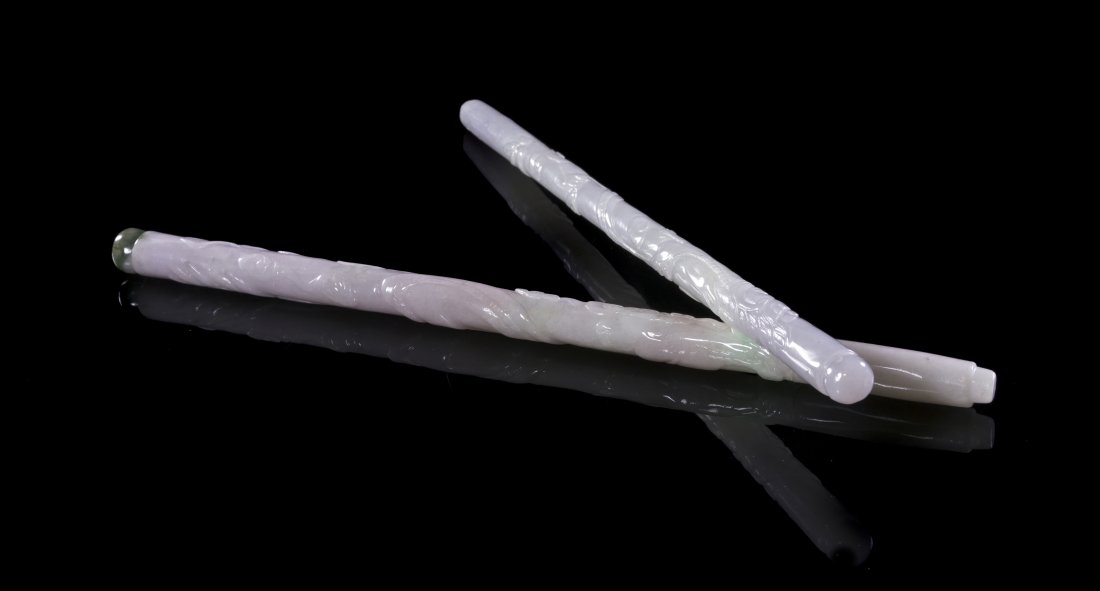 A Group of Two Jadeite Calligraphy Brush Handles, Lengt: A Group of Two Jadeite Calligraphy Brush Handles, of lavender, white and green colored stone, having relief carving throughout. Length of longer 11 5/8 inches.