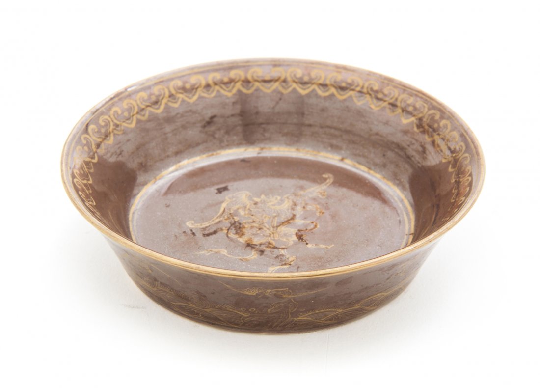 A Chinese Cafe-au-Lait Glazed Porcelain Dish, Diameter : A Chinese Cafe-au-Lait Glazed Porcelain Dish, having a flared mouth with repeating gilt lingzhi fungus-form decoration to the interior centered with a bat and foliage design, the exterior with bats so
