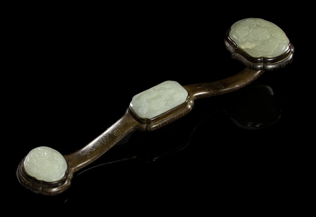 A Chinese Jade and Wood Ruyi Scepter, Length 18 1/4 inc: A Chinese Jade and Wood Ruyi Scepter, the celadon jade plaques relief carved and the wood frame having silver wire inlay. Length 18 1/4 inches.