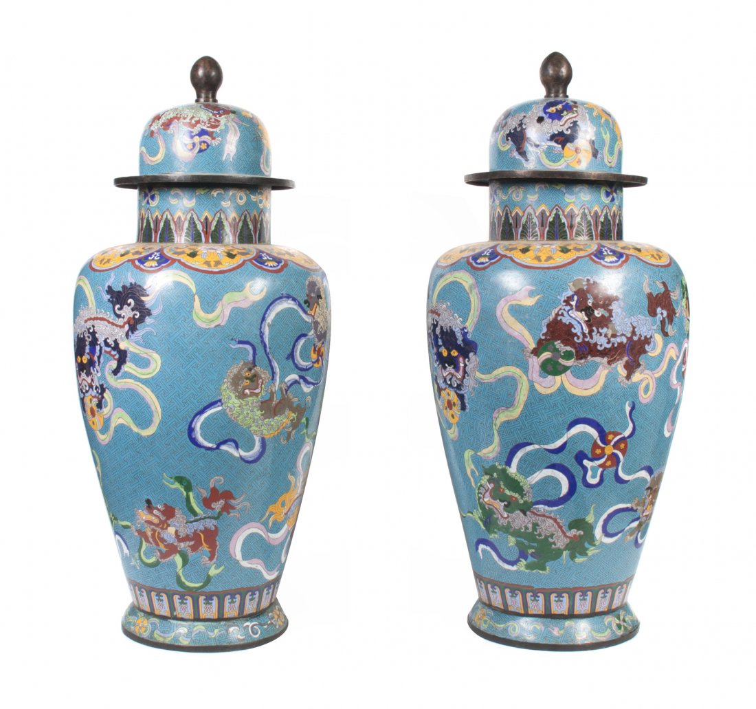 A Pair of Chinese Cloisonne Enameled Floor Vases, Heigh: A Pair of Chinese Cloisonne Enameled Floor Vases, each of lidded baluster form, depicting temple lions with cascading ribbons and balls on a patterned geometric ground. Height overall 38 1/4 inches.