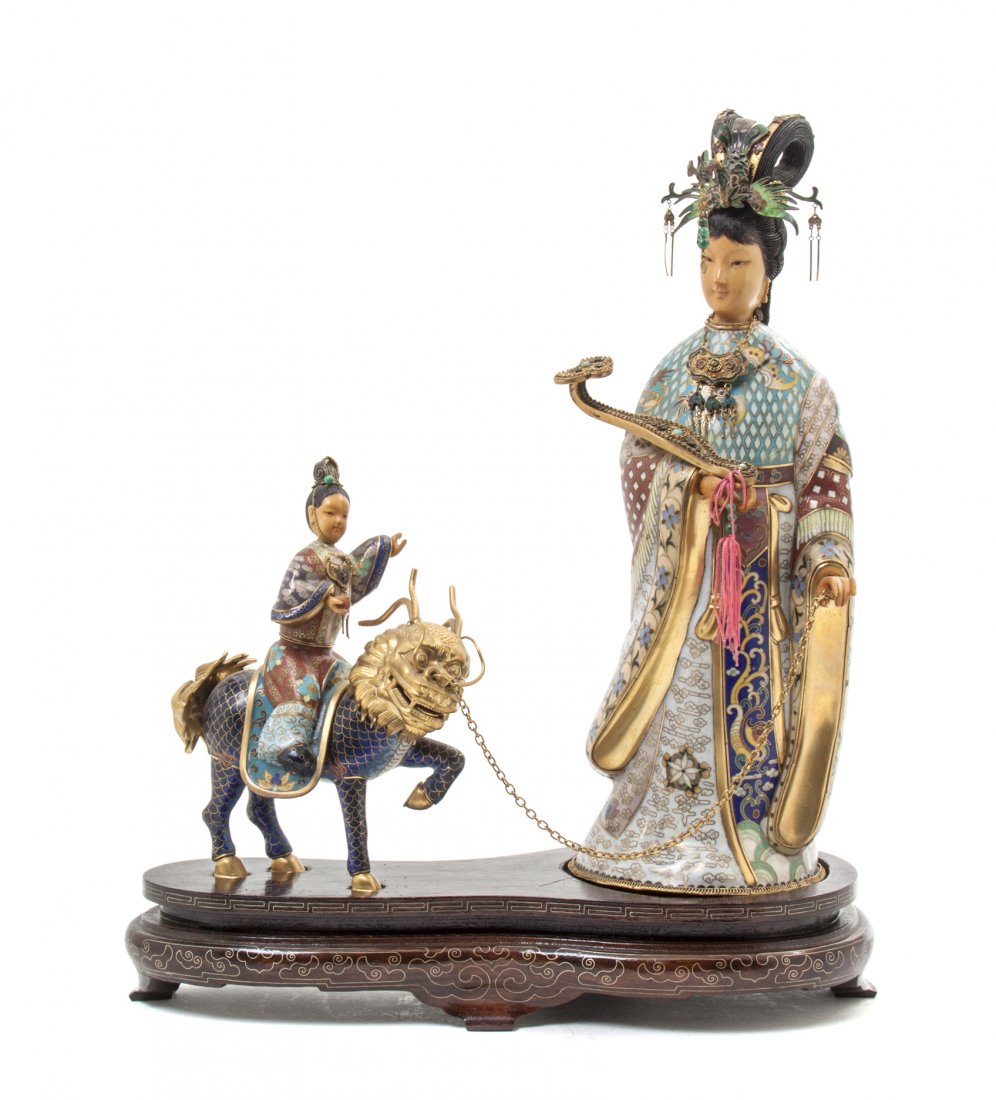 A Chinese Cloisonne Enamel and Ivory Figural Group, Hei: A Chinese Cloisonne Enamel and Ivory Figural Group, depicting an empress holding a ruyi scepter, with a boy riding a qilin, raised on a wood base having wire inlay. Height 14 inches. Property from the