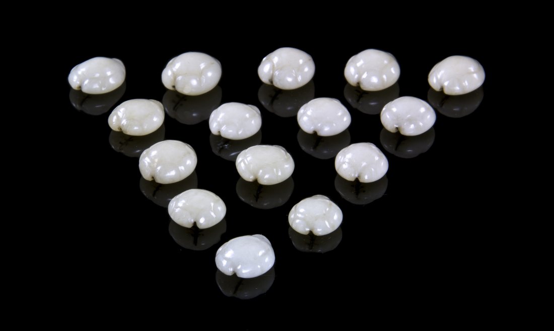 A Cased Set of Fifteen Carved Hardstone Articles, Lengt: A Cased Set of Fifteen Carved Hardstone Articles, of an even white stone, each modeled after a cowrie shell, contained in a fitted European case, possibly game pieces. Length of average 3/4 inches. Pr