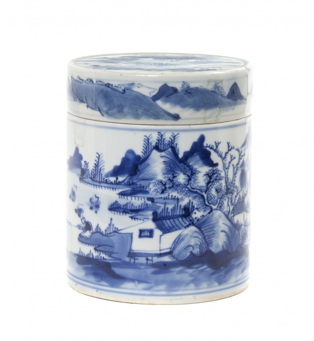 A Chinese Blue and White Porcelain Lidded Box, Height 5: A Chinese Blue and White Porcelain Lidded Box, of circular form, depicting figures in a mountain landscape with houses and trees. Height 5 7/8 inches.