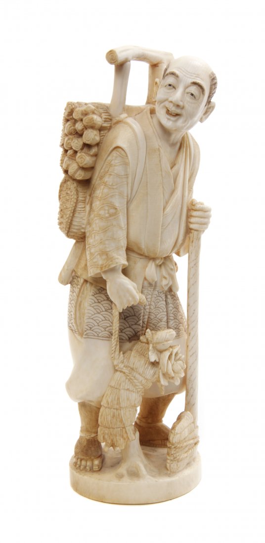 A Japanese Carved Ivory Okimono, Height 7 1/4 inches.: A Japanese Carved Ivory Okimono, depicting a man with a bundle of wood on his back, holding an axe in one hand and a bouquet of flowers in the other, raised on a naturalistic base bearing inlaid signa
