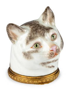 A Meissen Porcelain and Gilt-Metal Mounted Snuff Box: A Meissen Porcelain and Gilt-Metal Mounted Snuff Box 18th Century in the form of a cat's head with blue crossed-swords mark on back of neck. Height 2 3/4 inches.