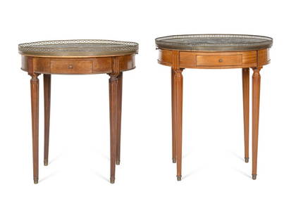 A Near Pair of Louis XVI Style Brass Mounted Mahogany Marble-Top Side Tables: A Near Pair of Louis XVI Style Brass Mounted Mahogany Marble-Top Side Tables Mid-20th Century with slightly varied brass gallery trim. Height 28 x diameter 25 1/2 inches.