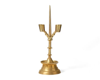 A Flemish Brass Double-Light Candlestick
