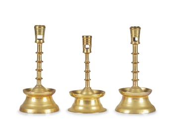 A Group of Three Flemish Brass Candlesticks