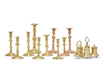 A Group of Ten Brass Candlesticks and a Brass Standish