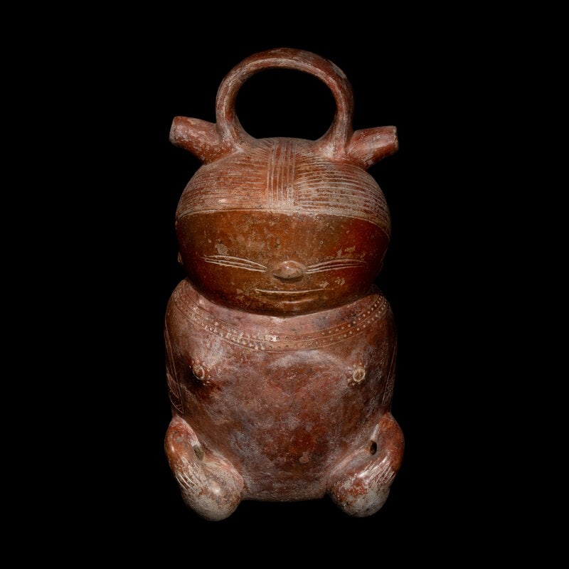 A Calima Redware Anthropomorphic Alcarraza: A Calima Redware Anthropomorphic Alcarraza Colombia, Circa 100 B.C.-800 A.D. Height 10 inches (25.4 cm). This lot is located in Chicago. Size Height 10 inches (25.4 cm).