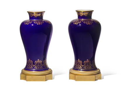 JAMIE DRAKE
A Pair of Sevres Porcelain 'Bleu du Roi' Parcel-Gilt and Gilt-Bronze Mounted Vases: JAMIE DRAKE A Pair of Sevres Porcelain 'Bleu du Roi' Parcel-Gilt and Gilt-Bronze Mounted Vases Green Lozenge Mark for 1855 and Iron-Red Crowned N Gilders Mark for 1865; the Mounts Late 19th