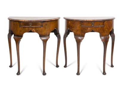 A Pair of Georgian Style Burl Walnut Demilune Console Tables: A Pair of Georgian Style Burl Walnut Demilune Console Tables English, Early 20th Century Each having an ogee-form apron with central drawer, raised on four legs terminating in pad feet. Height 30 x