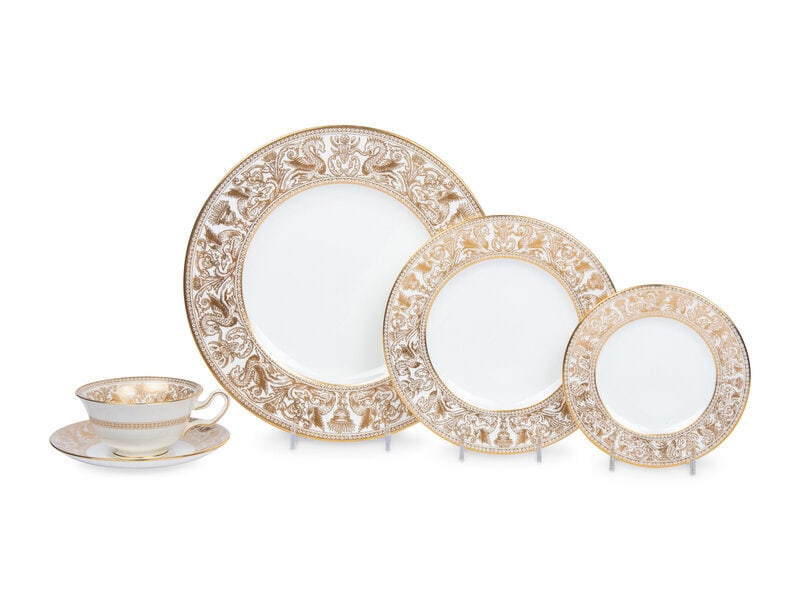 A Wedgwood Gold Florentine Porcelain Dinner Service: A Wedgwood Gold Florentine Porcelain Dinner Service 20th Century comprising: 8 dinner plates, 8 salad plates, 8 bread plates, 7 teacups and saucers, together with an additional saucer.
