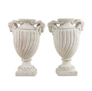 A Pair of Neoclassical Style Marble Urns: A Pair of Neoclassical Style Marble Urns 20th Century with damage to one of the ram heads. Height 31 1/2 x width (over handles) 21 x depth 14 inches. This lot is locat