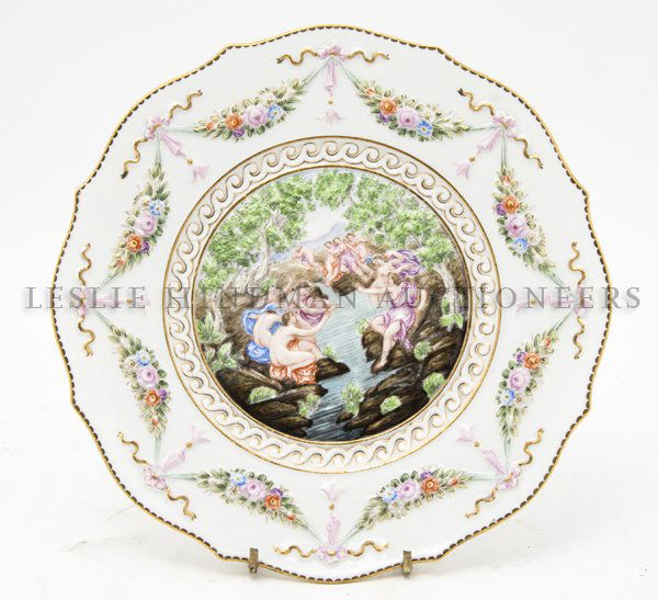 A Capodimonte Porcelain Plate, Diameter 8 5/8 inches.: A Capodimonte Porcelain Plate, decorated with maidens bathing by a stream in relief. Diameter 8 5/8 inches.