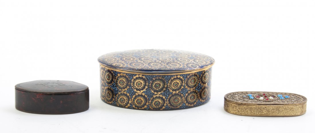 A Collection of Three Decorative Boxes, Width of first : A Collection of Three Decorative Boxes, comprising a Royal Vienna style oval box, a silver mounted tortoise shell box and a diminutive compact. Width of first 5 1/2 inches. Property from the Estate of