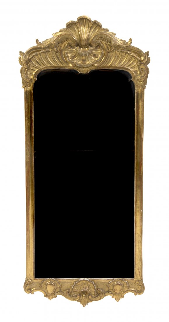 A George II Style Giltwood Pier Mirror, Height 47 x wid: A George II Style Giltwood Pier Mirror, 19th century, having a foliate and shell crest over a beveled vertical glass plate. Height 47 x width 20 inches. Property from the Estate of a Florida and South
