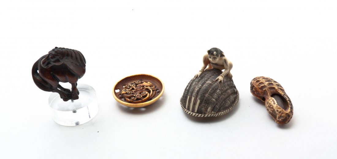 Three Japanese Ivory Articles, Width of widest 2 inches: Three Japanese Ivory Articles, comprising a peanut netsuke, a carved circular plaque and an okimono of an oni on a woven basket, together with a wood horse netsuke on a lucite stand. Width of widest 2