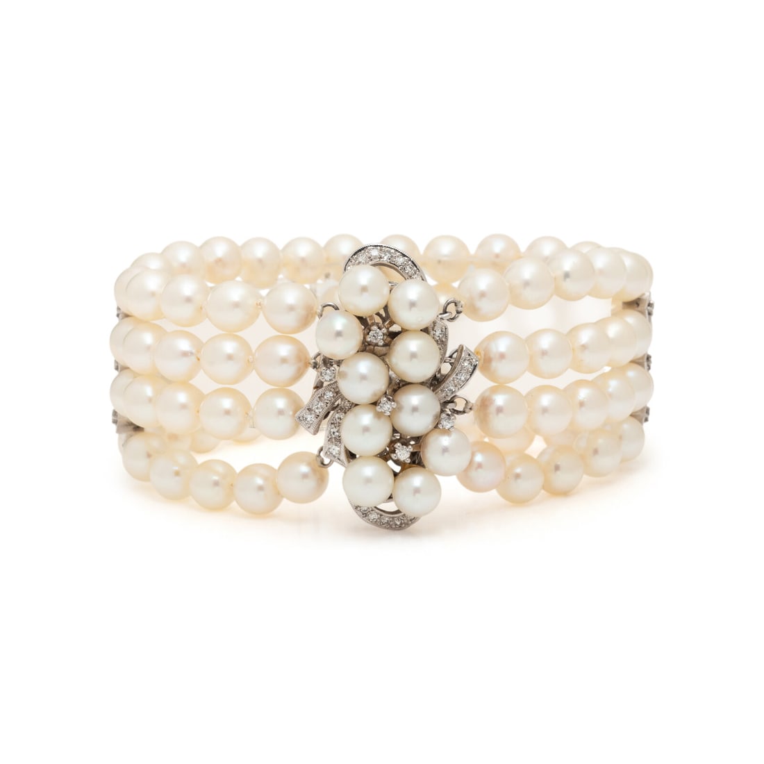 CULTURED PEARL AND DIAMOND BRACELET: CULTURED PEARL AND DIAMOND BRACELET Cultured pearls measuring approximately 6.00 - 6.50 mm and round and single cut diamonds. White gold. 7 inches long, 1 inch wide. Gross weight: 32.65 dwt. This lot