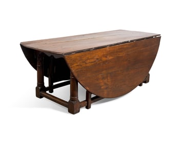 A Large Baroque Style Oak Drop-Leaf Dining Table
