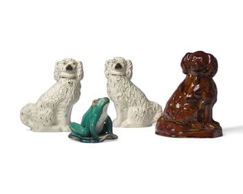 A Group of Four Ceramic Figures: Three Spaniels and a Frog