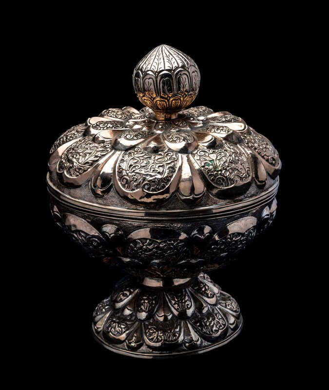 A Southeast Asian Silvered Metal Covered Pedestal Bowl: A Southeast Asian Silvered Metal Covered Pedestal Bowl 20th Century the bowl and covered worked with various petal designs, surmounted by a knob finial. Height 11 x diameter 8 1/2 in., 27.9